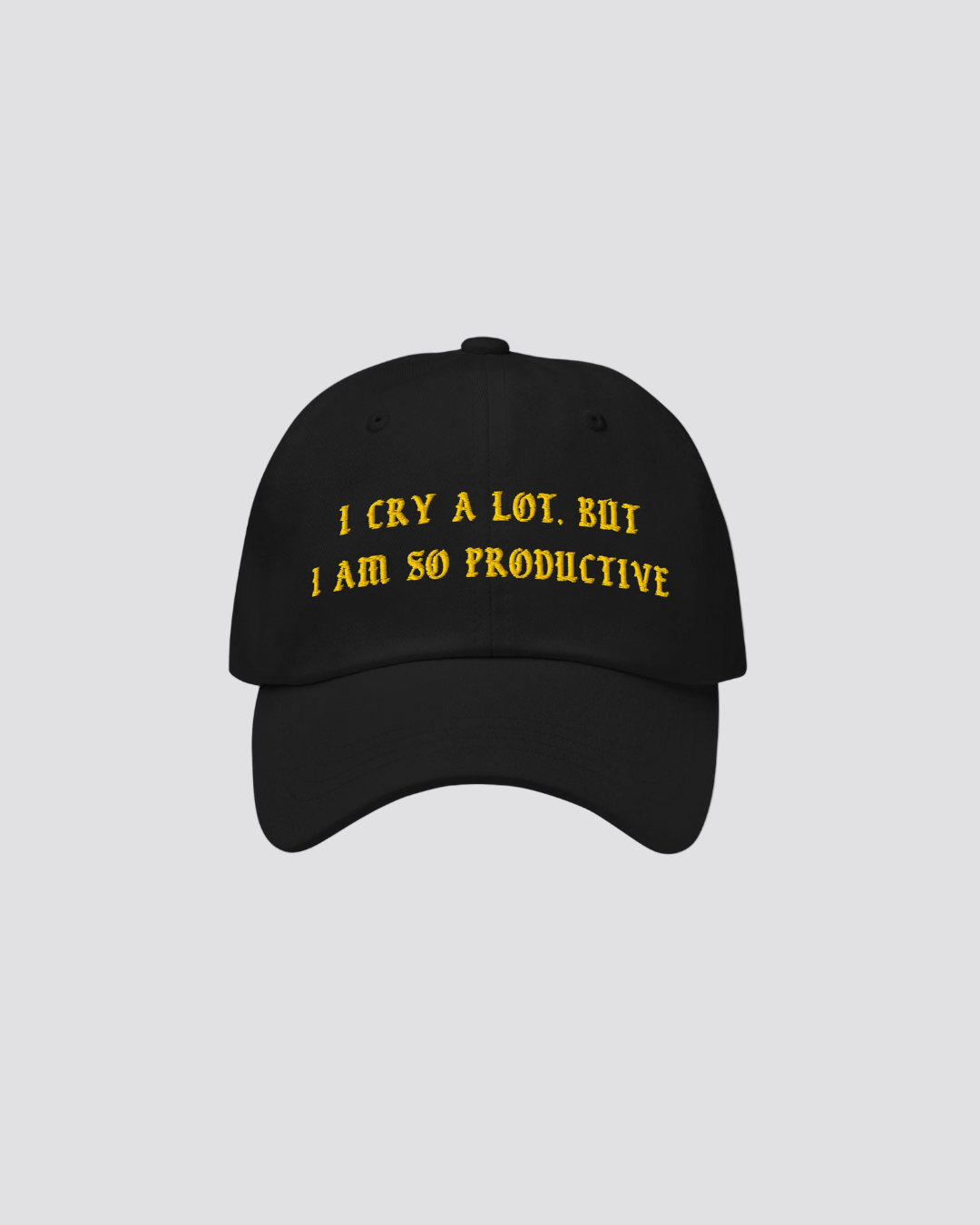 Black cap with yellow text on a beige background