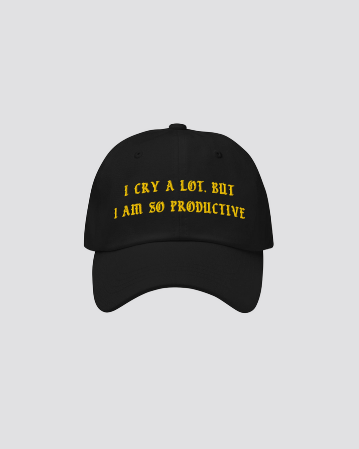 Black cap with yellow text on a beige background