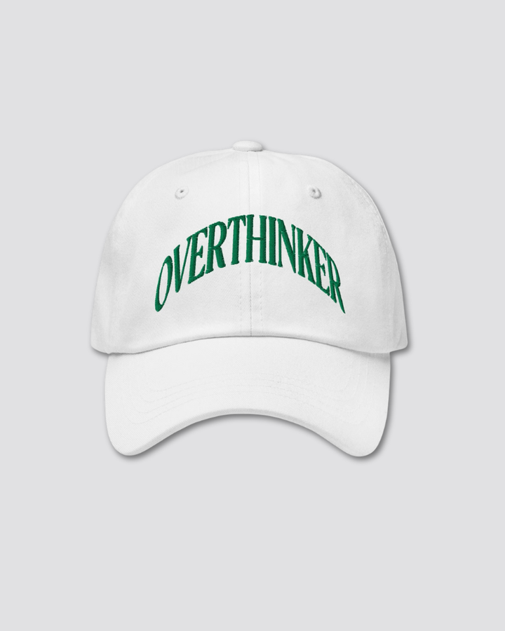 White cap with 'OVER THINKER' text in green on a light gray background