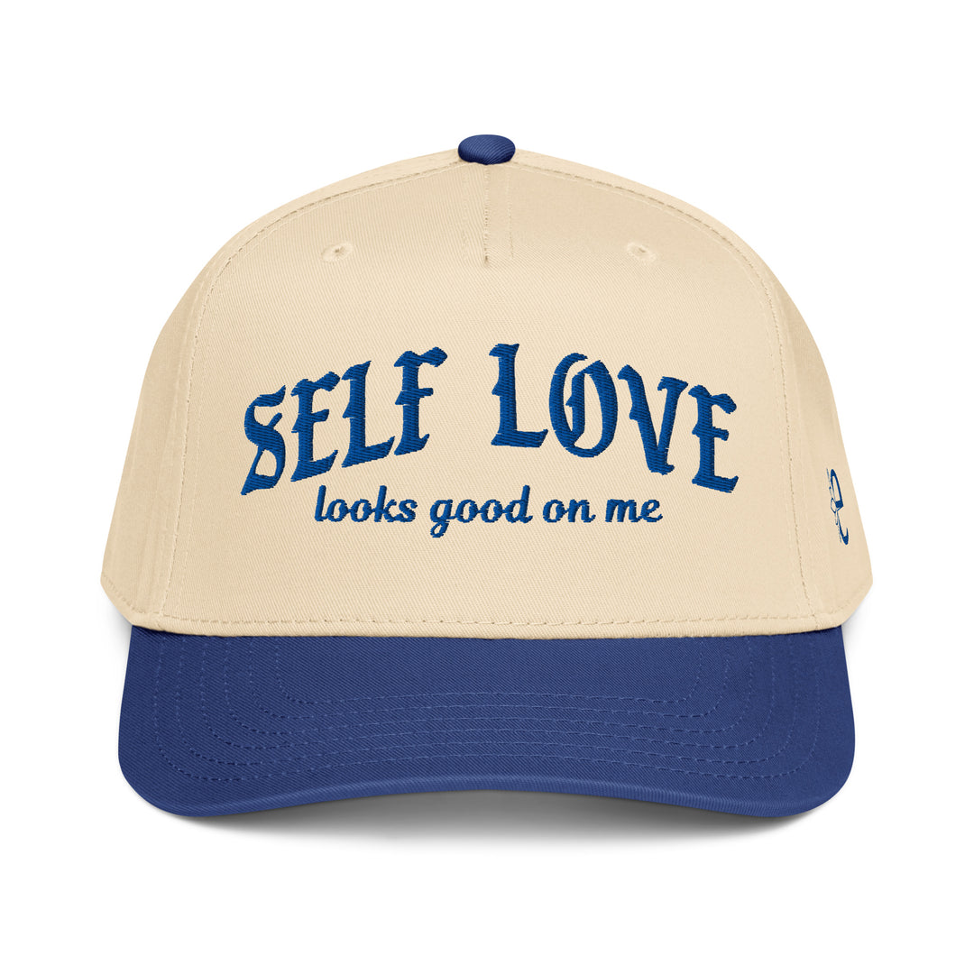Beige and blue cap with 'SELF LOVE looks good on me' text on a white background