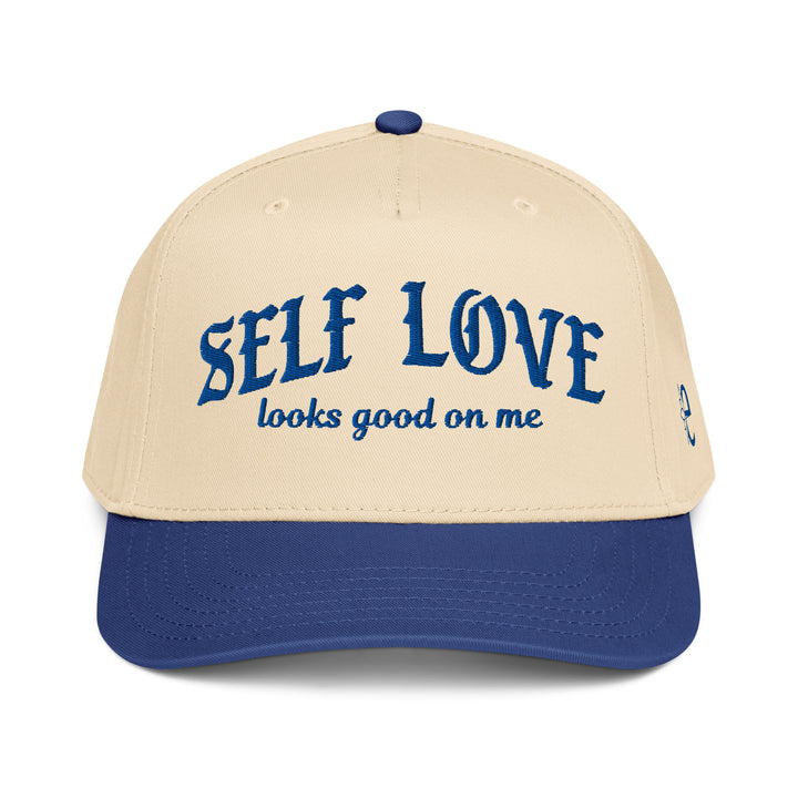 Beige and blue cap with 'SELF LOVE looks good on me' text on a white background