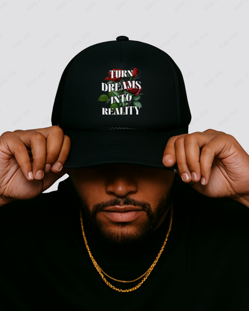 Person wearing a black cap with motivational text on a plain background