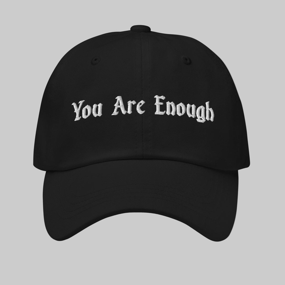 Black cap with 'You Are Enough' text on a white background