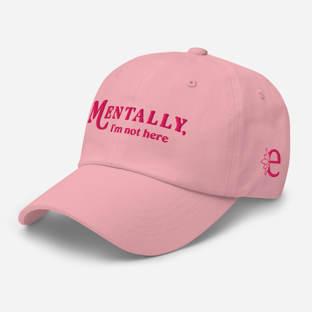 Pink cap with 'MENTALLY. I'm not here' text on a light gray background