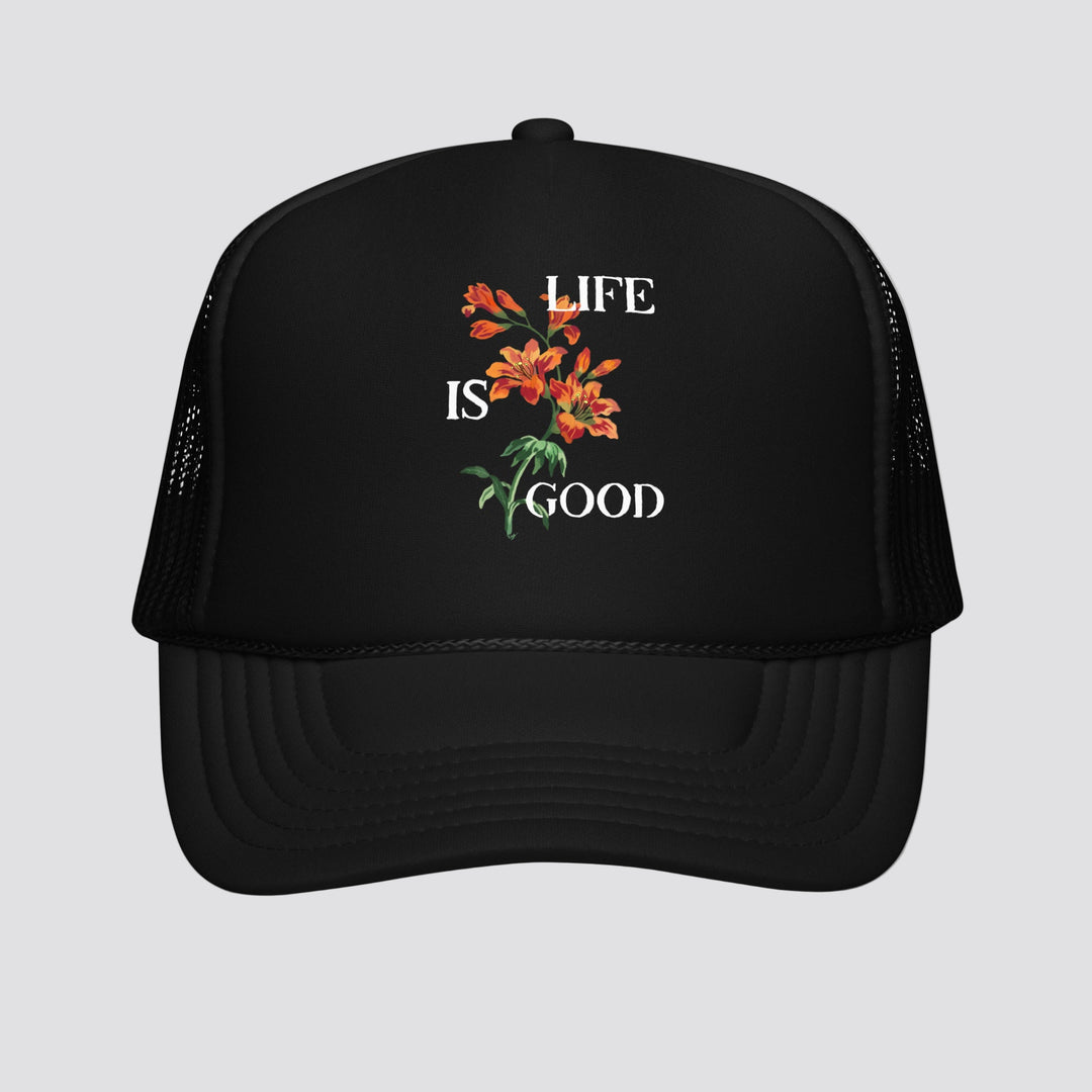 Black trucker hat with 'Life is Good' and floral design on a white background