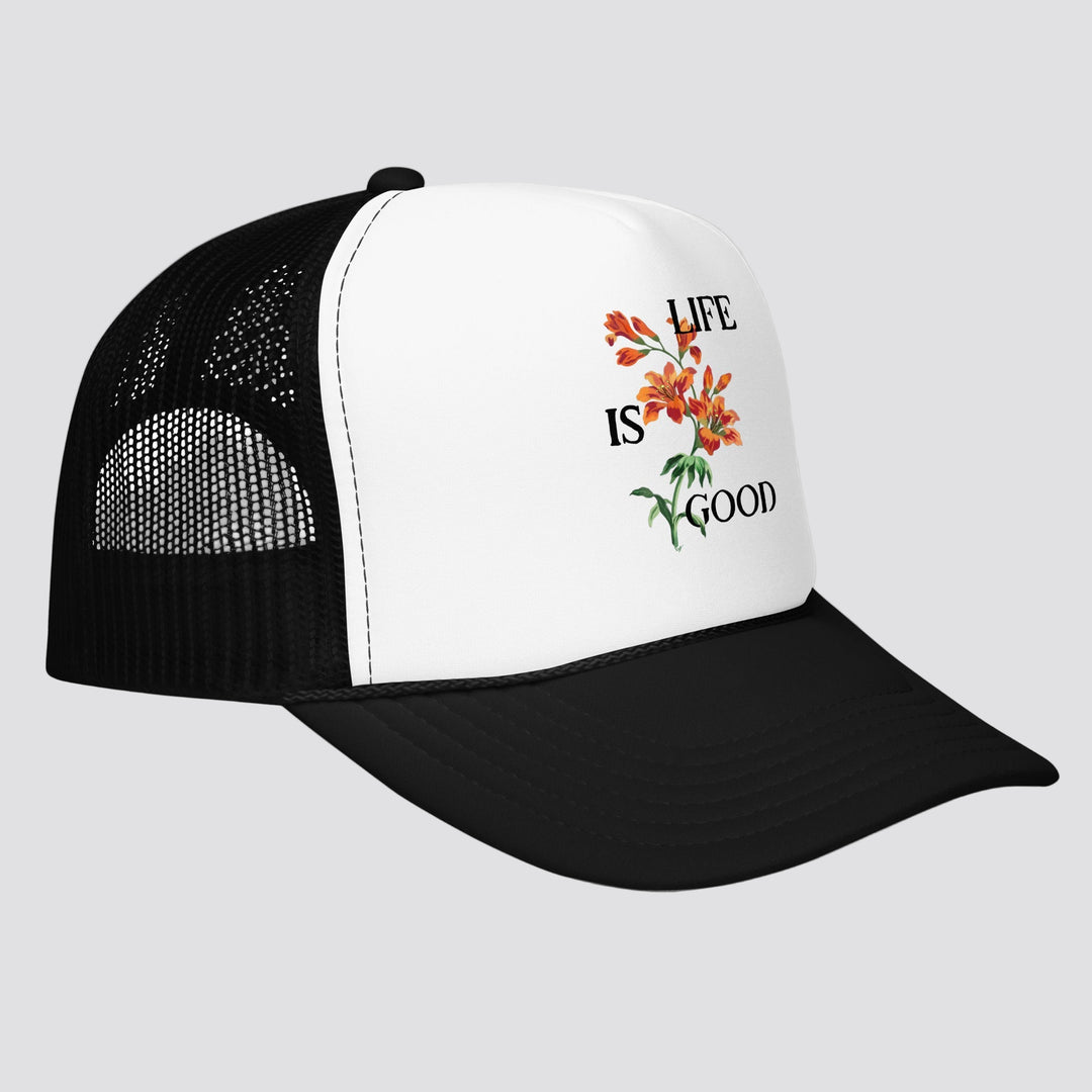 Black and white cap with 'Life is Good' floral design on a white background