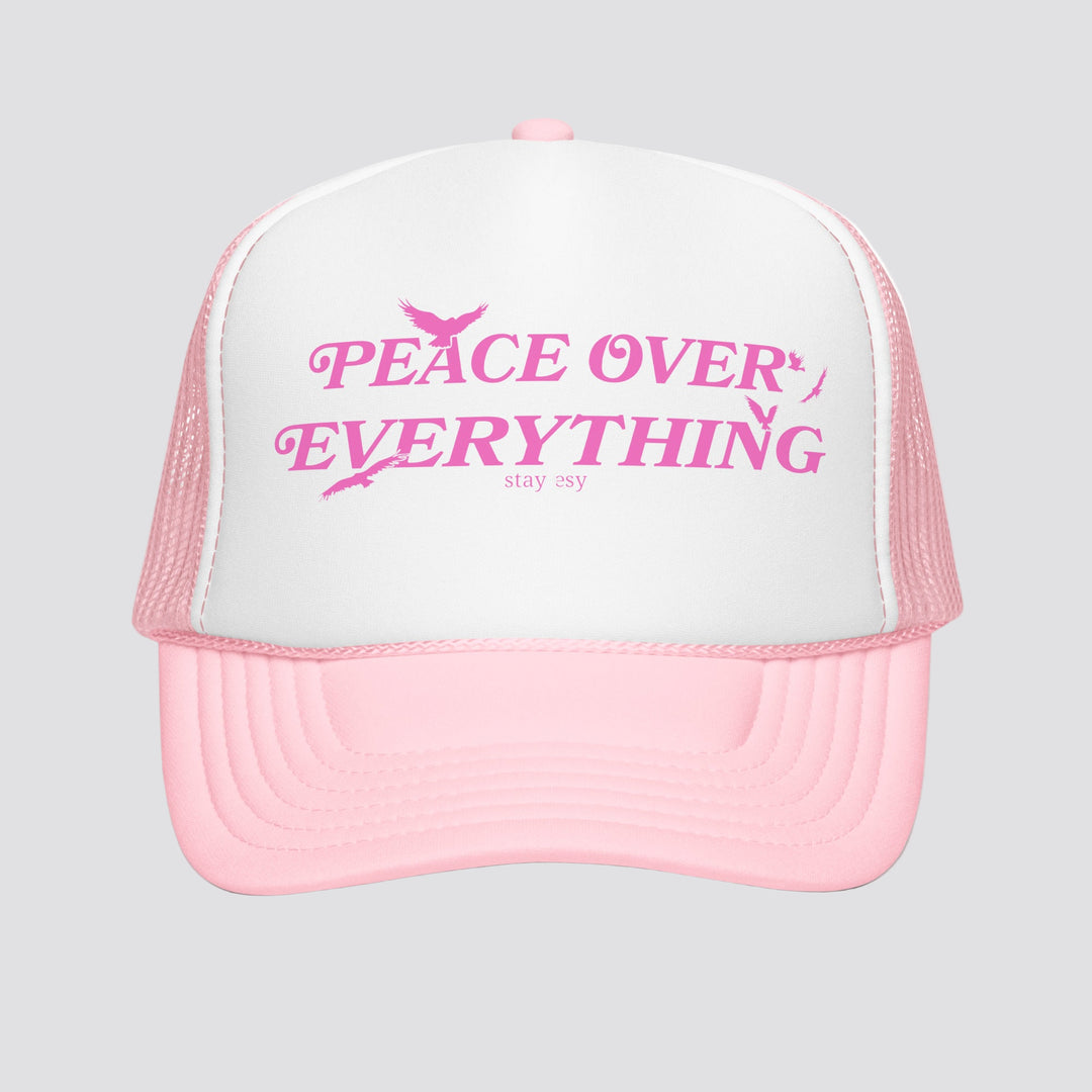 Pink and white cap with 'Peace Over Everything' text on a white background