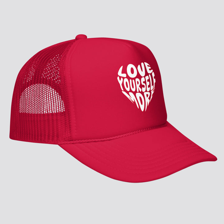Red cap with 'Love Yourself More' text on a white background