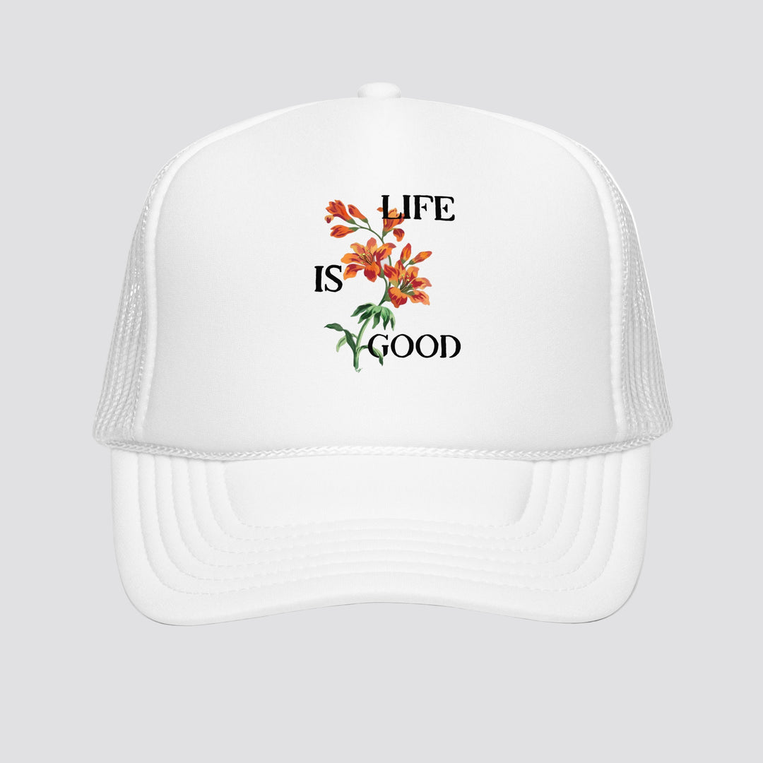 White cap with 'Life is Good' floral design on a white background