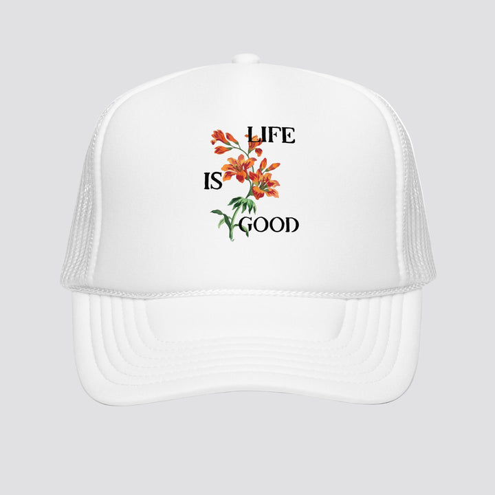 White cap with 'Life is Good' floral design on a white background