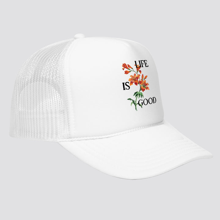 White cap with 'Life is Good' and floral design on a white background
