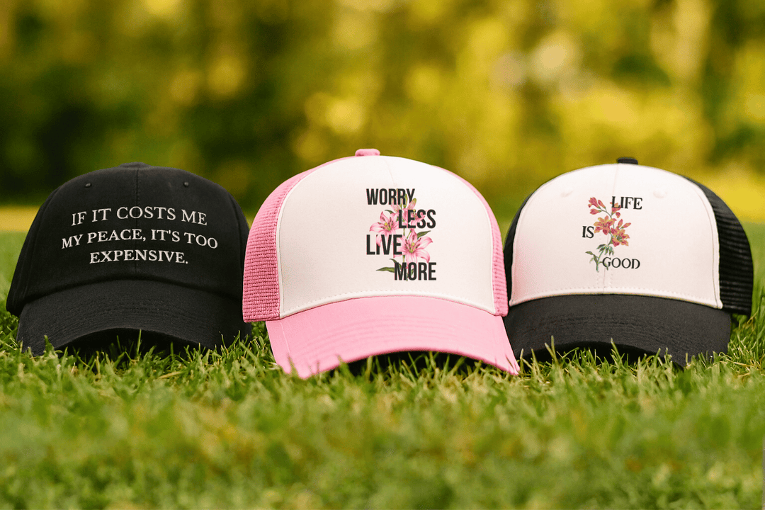 Collection of hats from Stay Esy laying on grass.