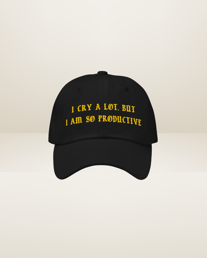 Black cap with yellow text on a beige background