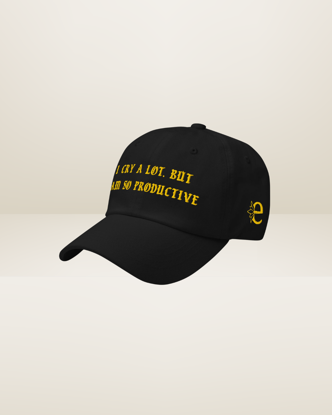 Black cap with yellow text and logo on a beige background