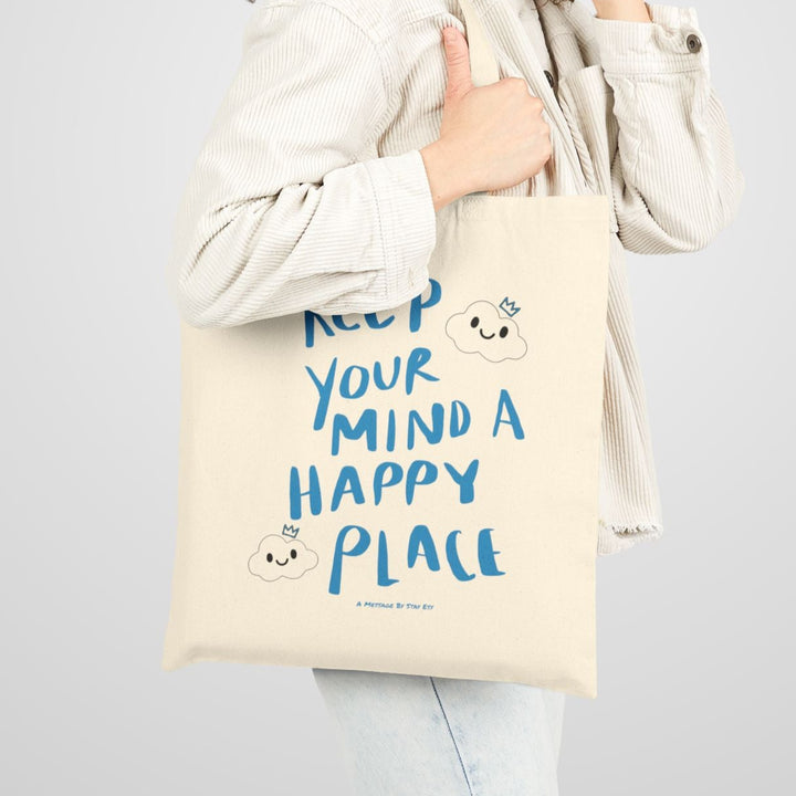 Woman holding a tote bag with text on a plain background