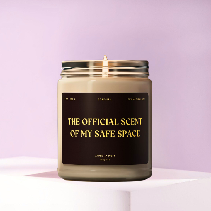 Candle in a glass jar with a black label on a light purple background