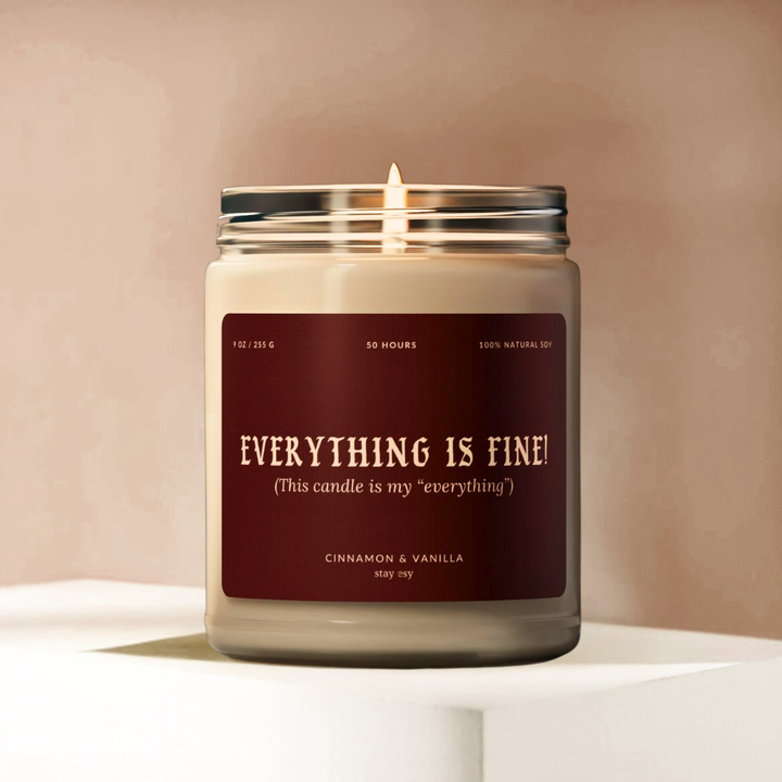 Candle with a label reading 'Everything is Fine!' on a neutral background