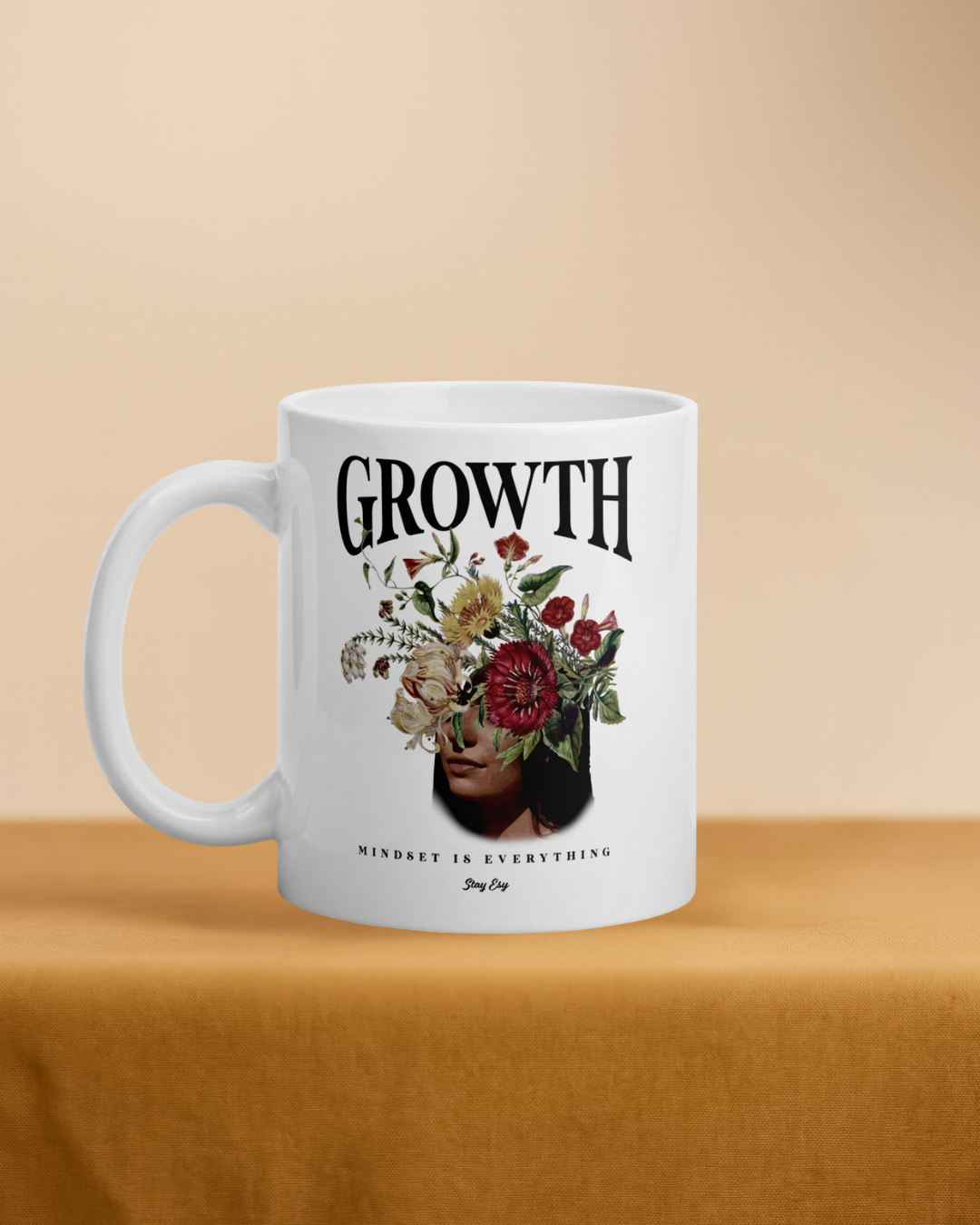 White mug with floral design and text on a beige background