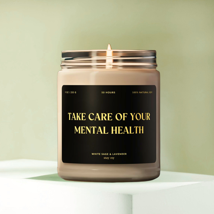 Candle in a jar with a label reading 'Take care of your mental health' on a light green background.