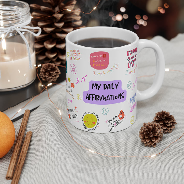 White ceramic mug featuring inspirational daily affirmations, perfect for morning coffee ritual and self-care routine