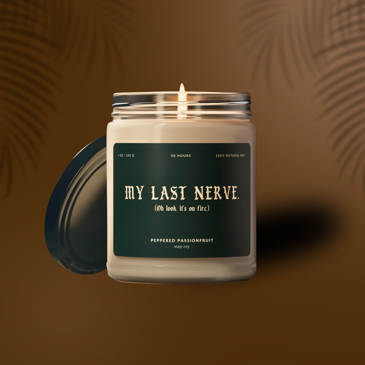 Candle in a glass jar with a green label on a brown background