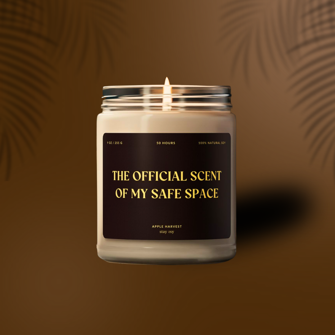 Candle in a glass jar with a black label on a brown background