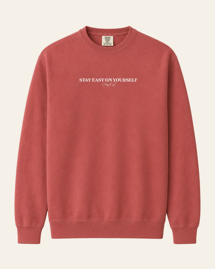 Crimson Unisex Comfort Colors Sweatshirt with stay easy on yourself text on the front.
