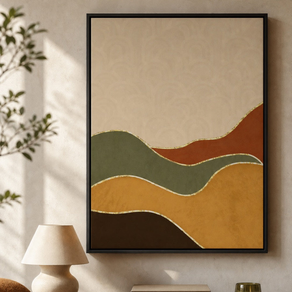 A framed abstract wall art print hangs on a beige wall above a wooden console table. The artwork features flowing, wavy shapes in muted mustard yellow, olive green, terracotta orange, dark brown, and cream, outlined with thin gold-like lines.