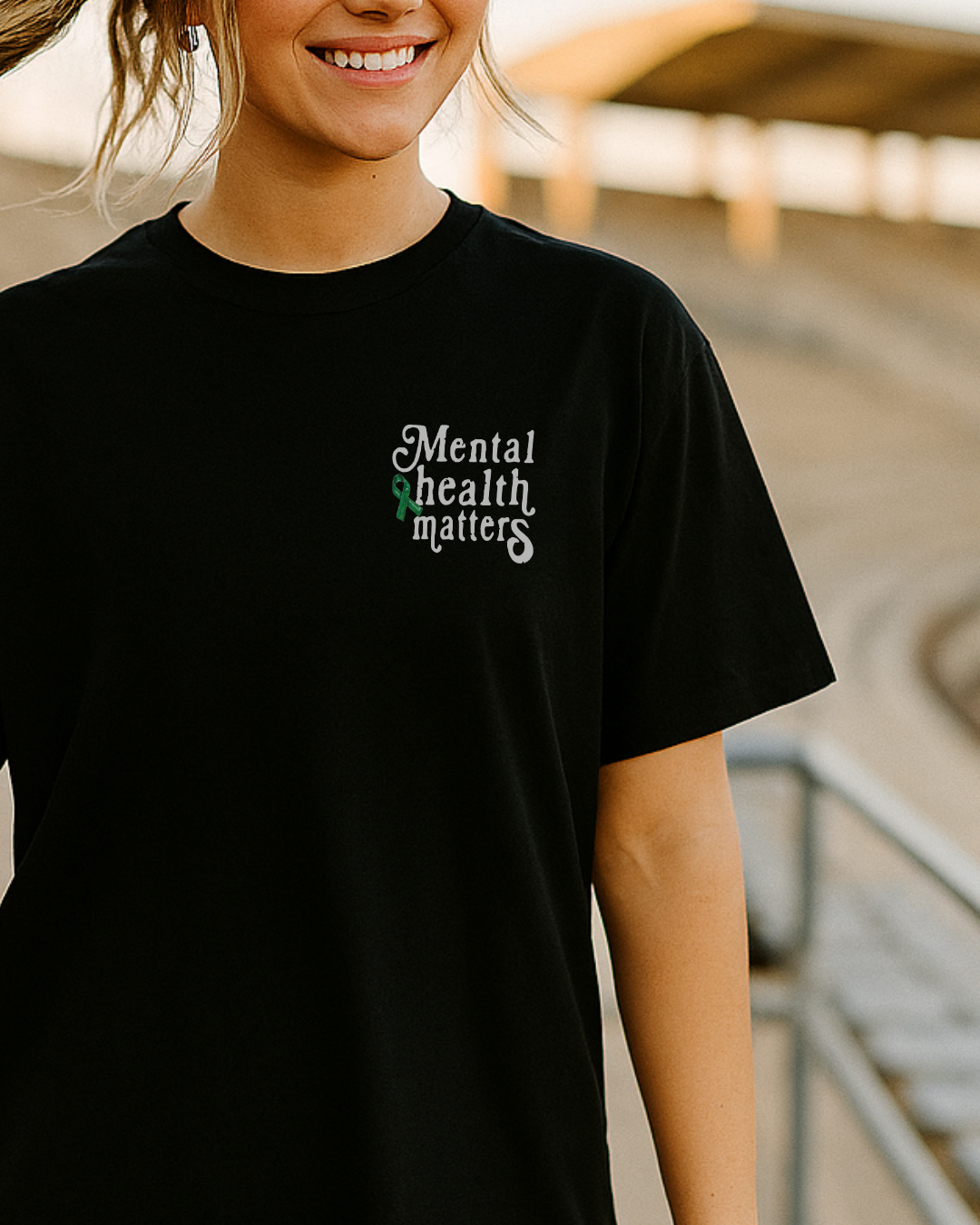 Person wearing a black t-shirt with 'Mental health matters' text.