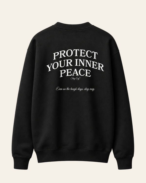 Black sweatshirt with 'Protect Your Inner Peace' text on a beige background