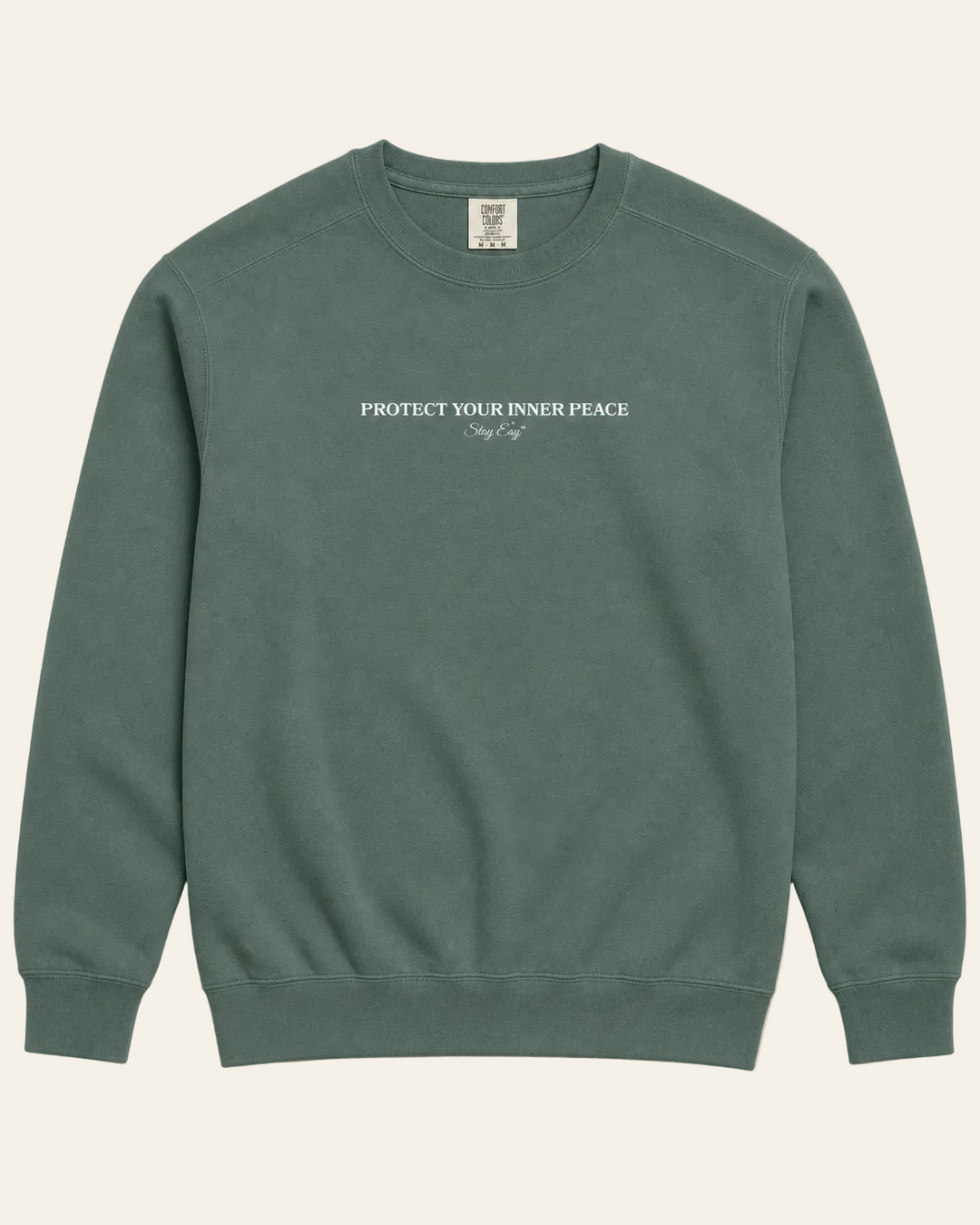 Green Unisex sweatshirt with "Protect Your inner Peace" text on a beige background