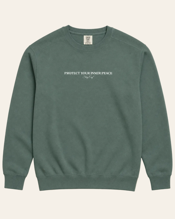 Green Unisex sweatshirt with "Protect Your inner Peace" text on a beige background