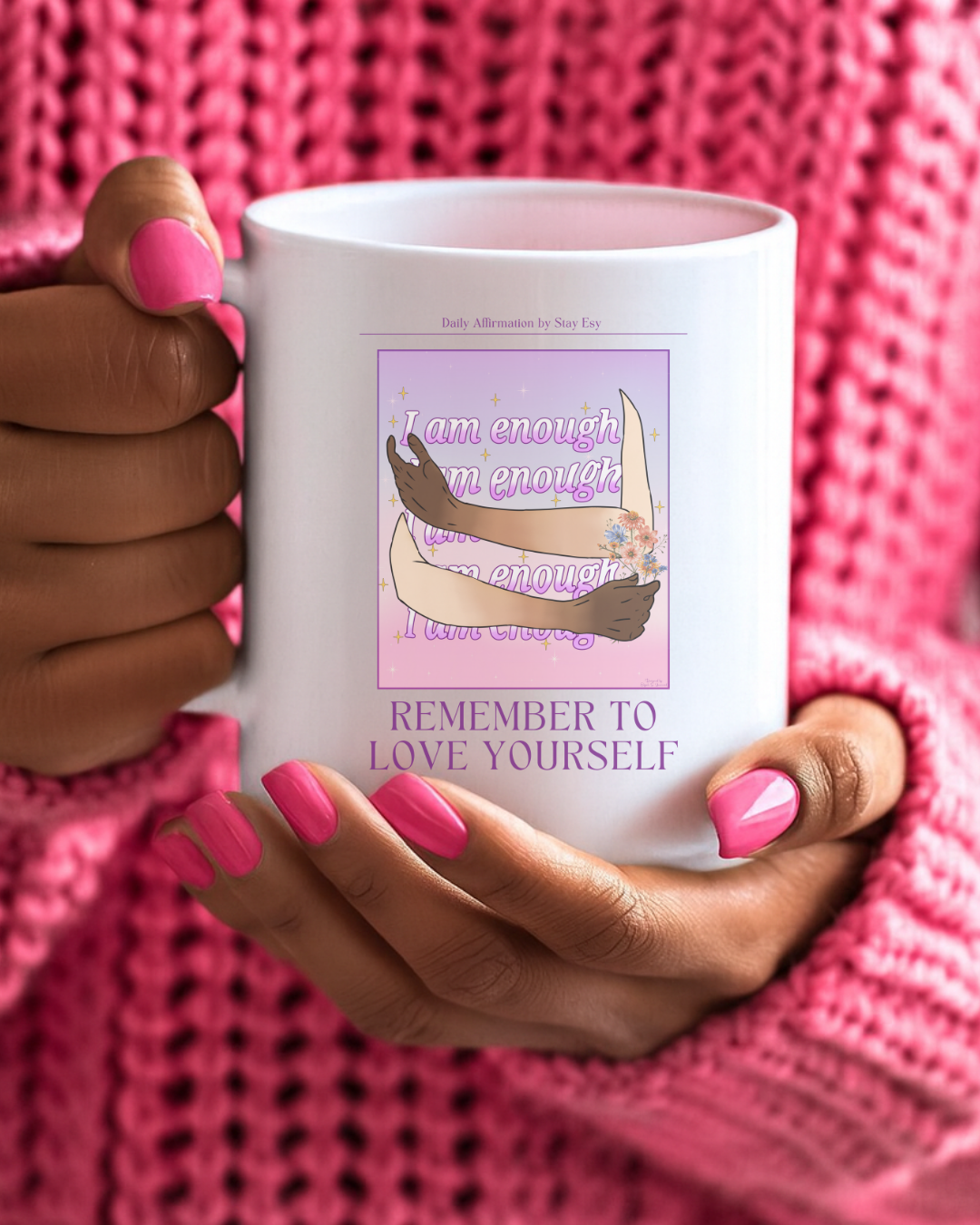 Person holding a mug with a motivational quote and illustration against a pink textured background