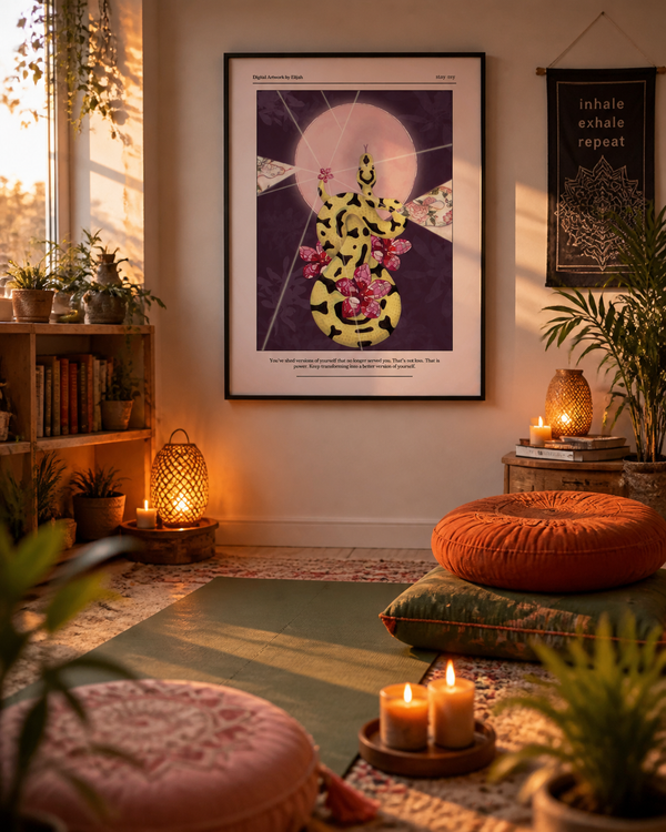 A framed art print featuring a stylized yellow and pink lotus flower on a dark purple background, displayed on a warm beige wall in a cozy, sunlit room with floor cushions, candles, and potted plants.