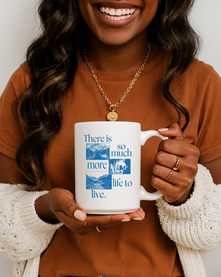 Person holding a mug with a motivational quote