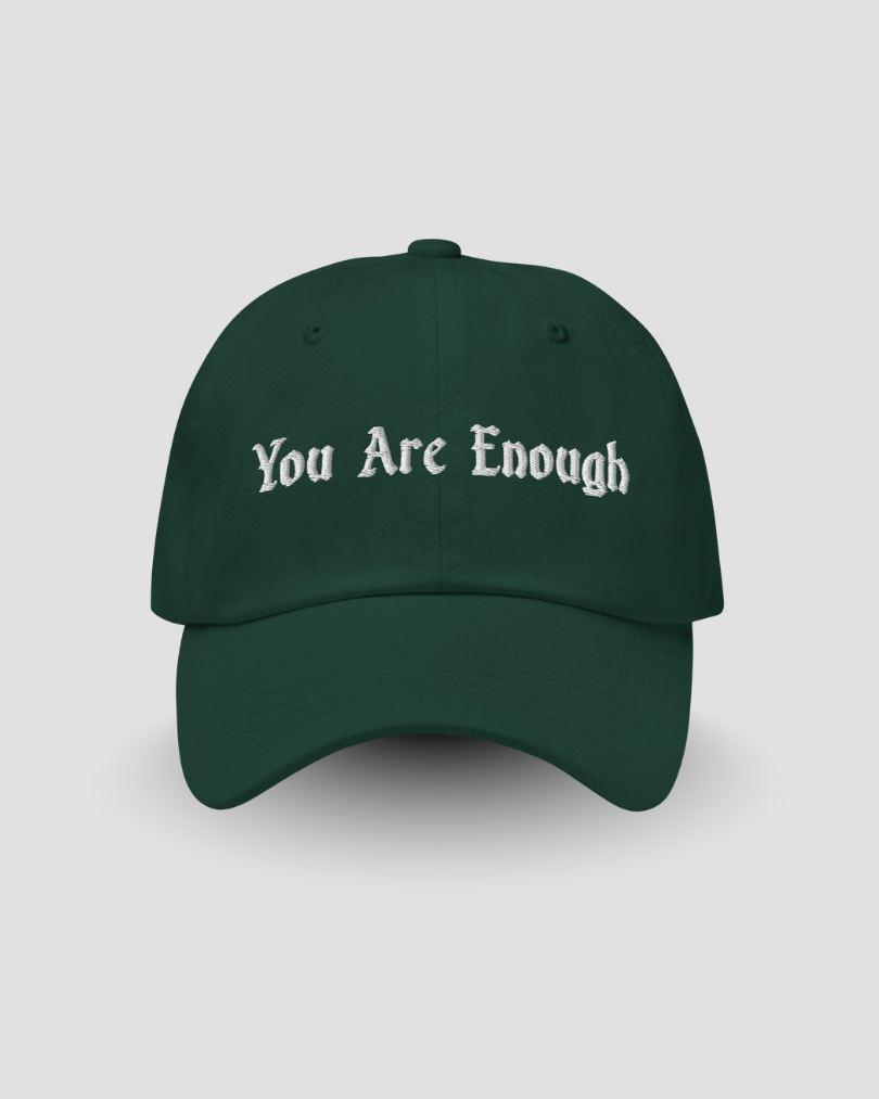 Green cap with 'You Are Enough' text on a light gray background