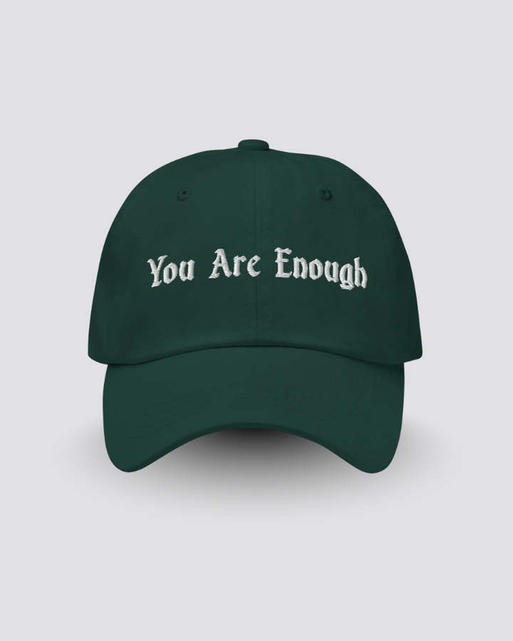 Green cap with 'You Are Enough' text on a light gray background