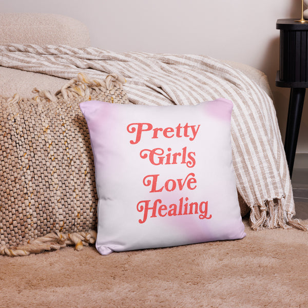 Decorative pillow with 'Pretty Girls Love Healing' text on a couch.