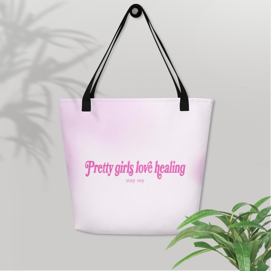 Tote bag with 'Pretty girls love healing' text on a light background