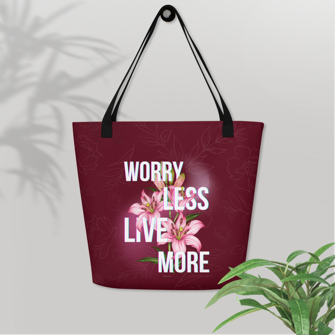 Tote bag with floral design and motivational text on a light gray background