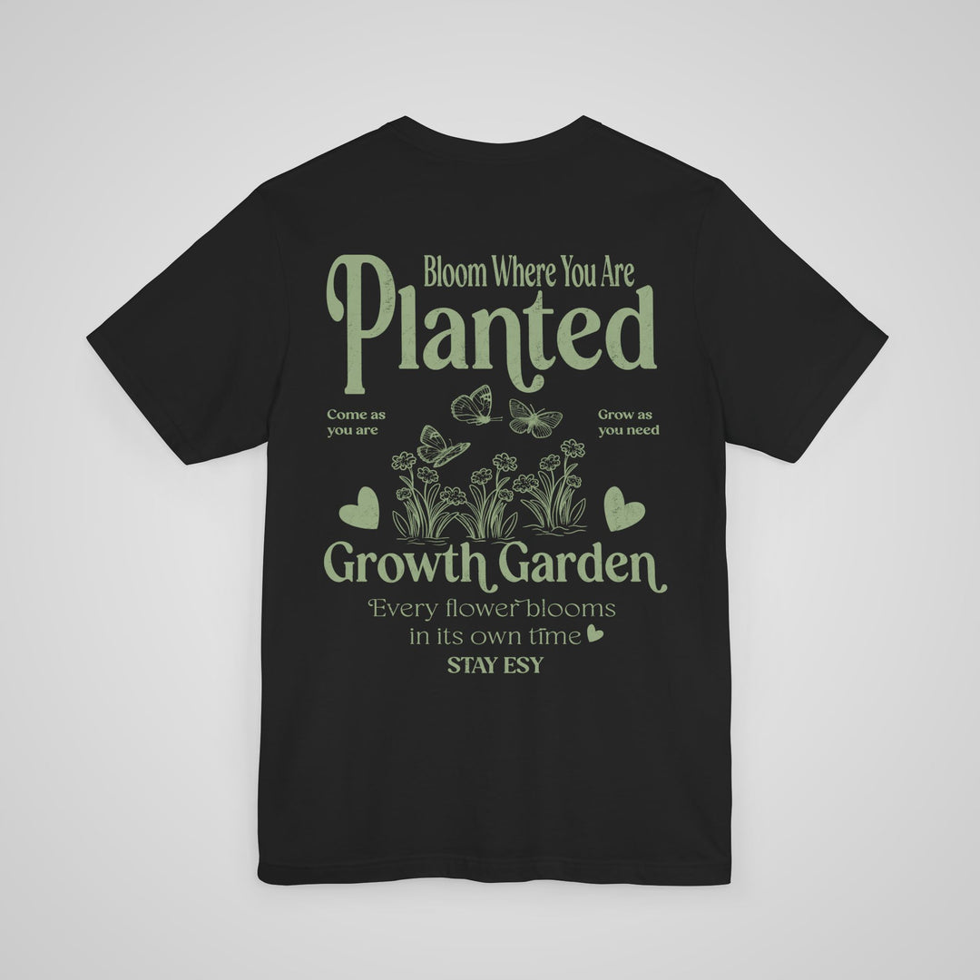 Back view of black mental health graphic tee with Bloom Where You Are Planted message