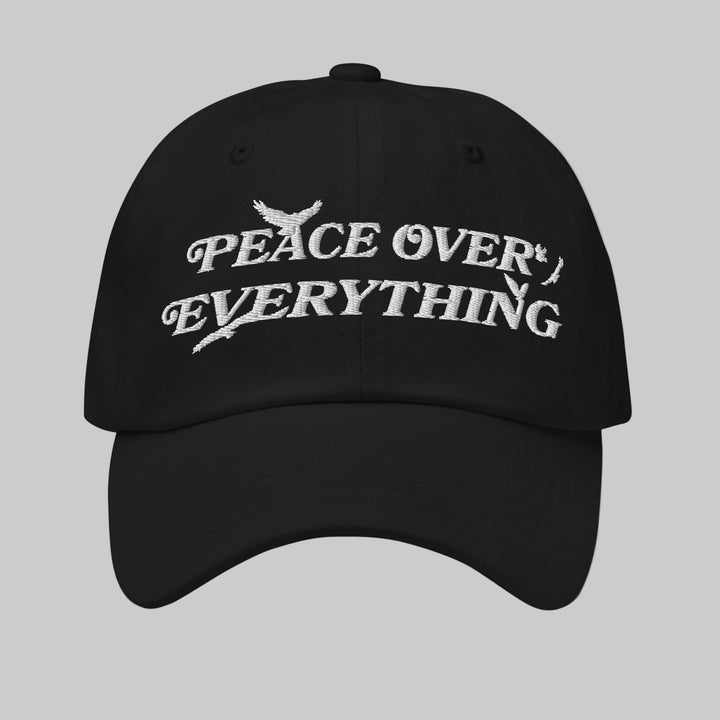 Black cap with 'Peace Over Everything' text on a white background