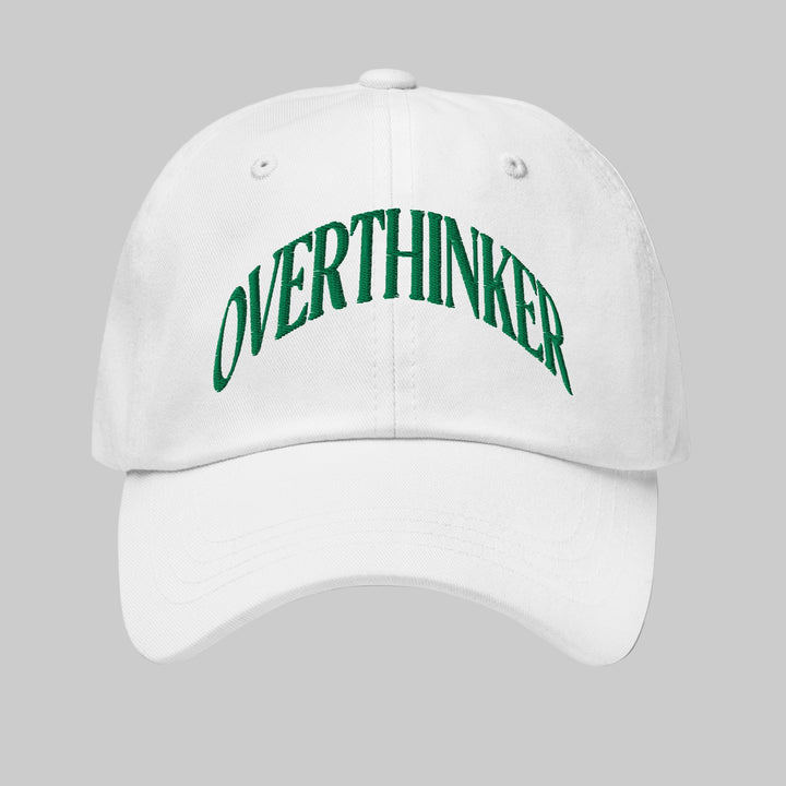 White cap with 'OVERTHINKER' text in green on a white background