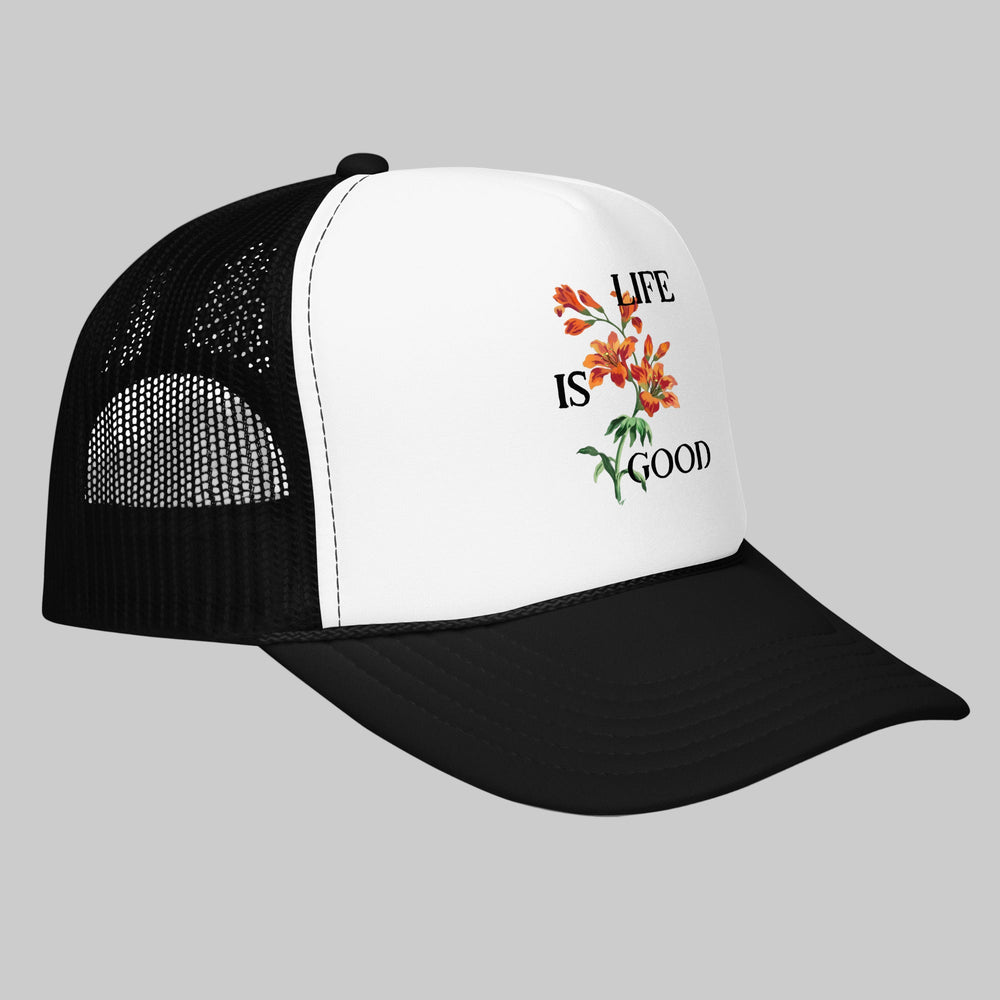 Black and white cap with 'Life is Good' floral design on a white background