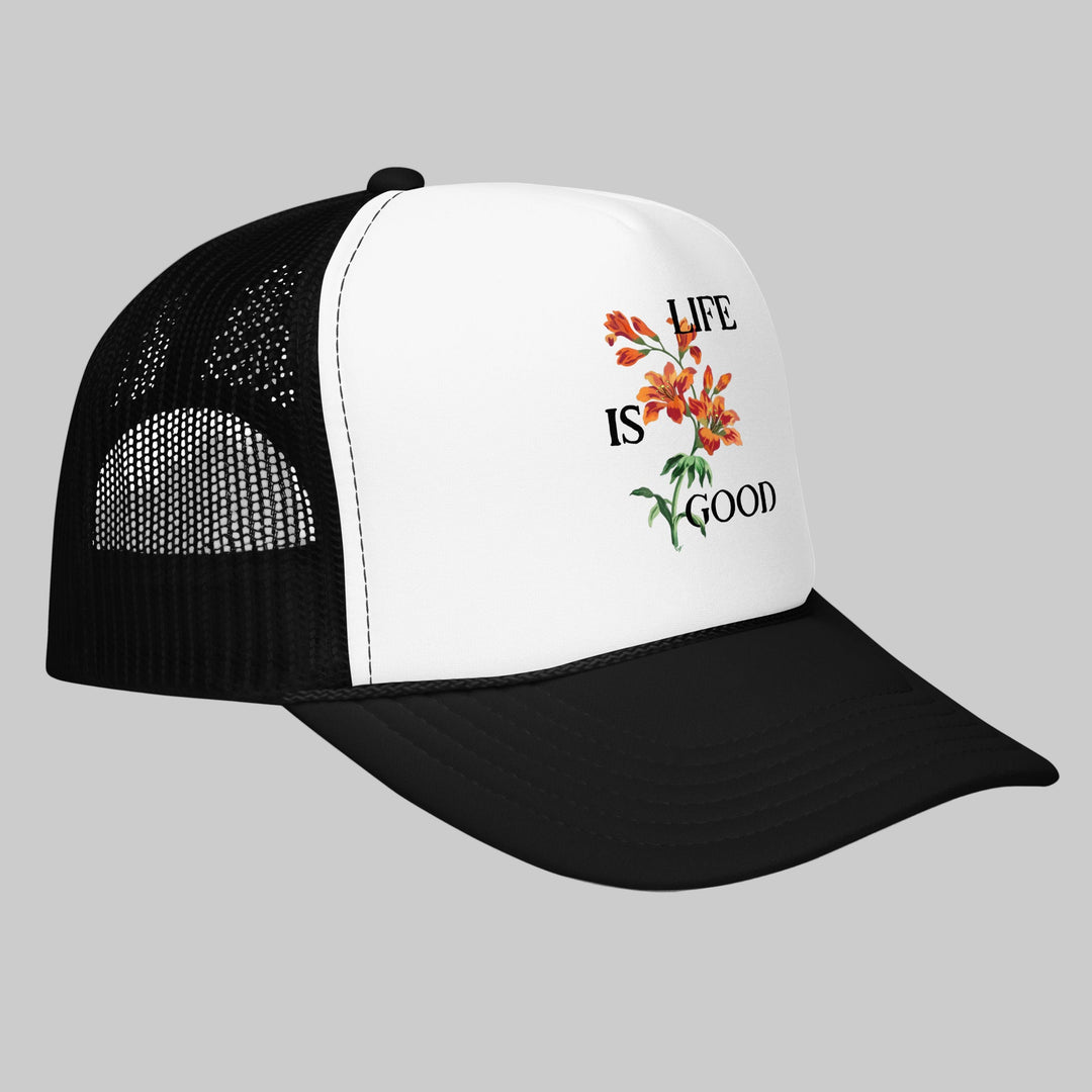 Black and white cap with 'Life is Good' floral design on a white background