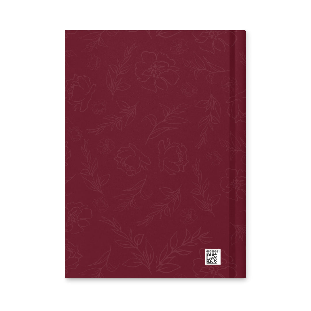 Red notebook with floral pattern on a white background