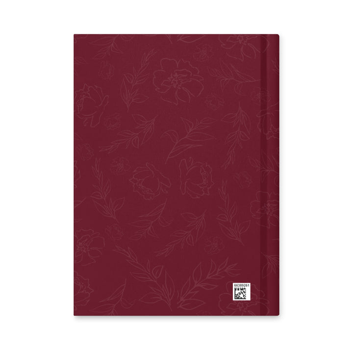 Red notebook with floral pattern on a white background