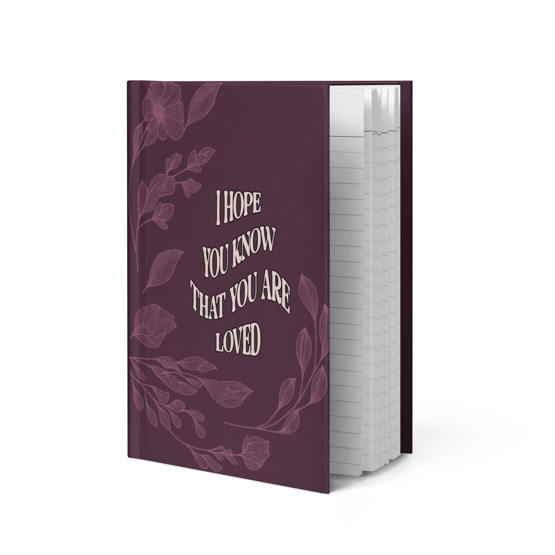 Purple notebook with floral design and text on a white background