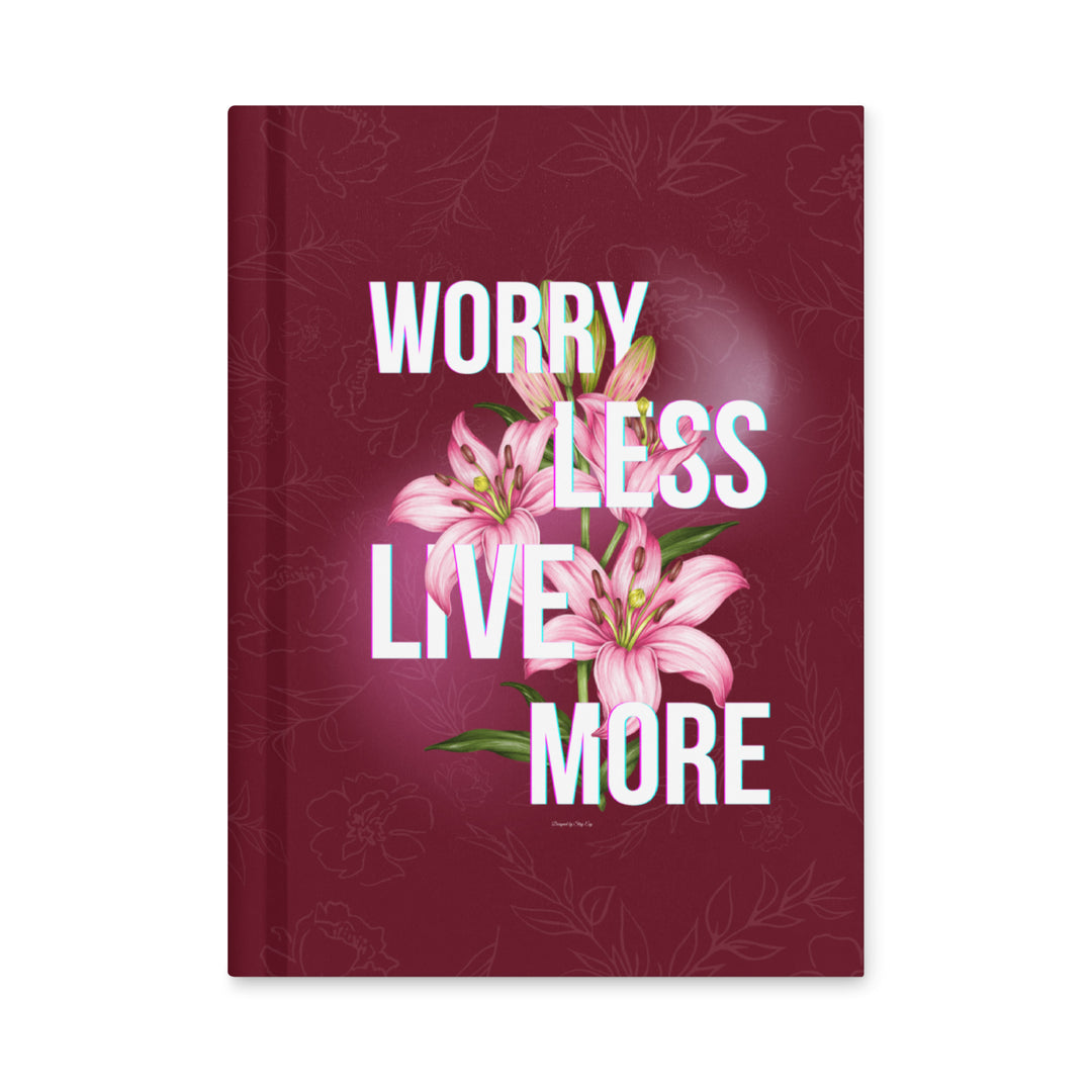 Book with pink flowers and motivational text on a maroon background