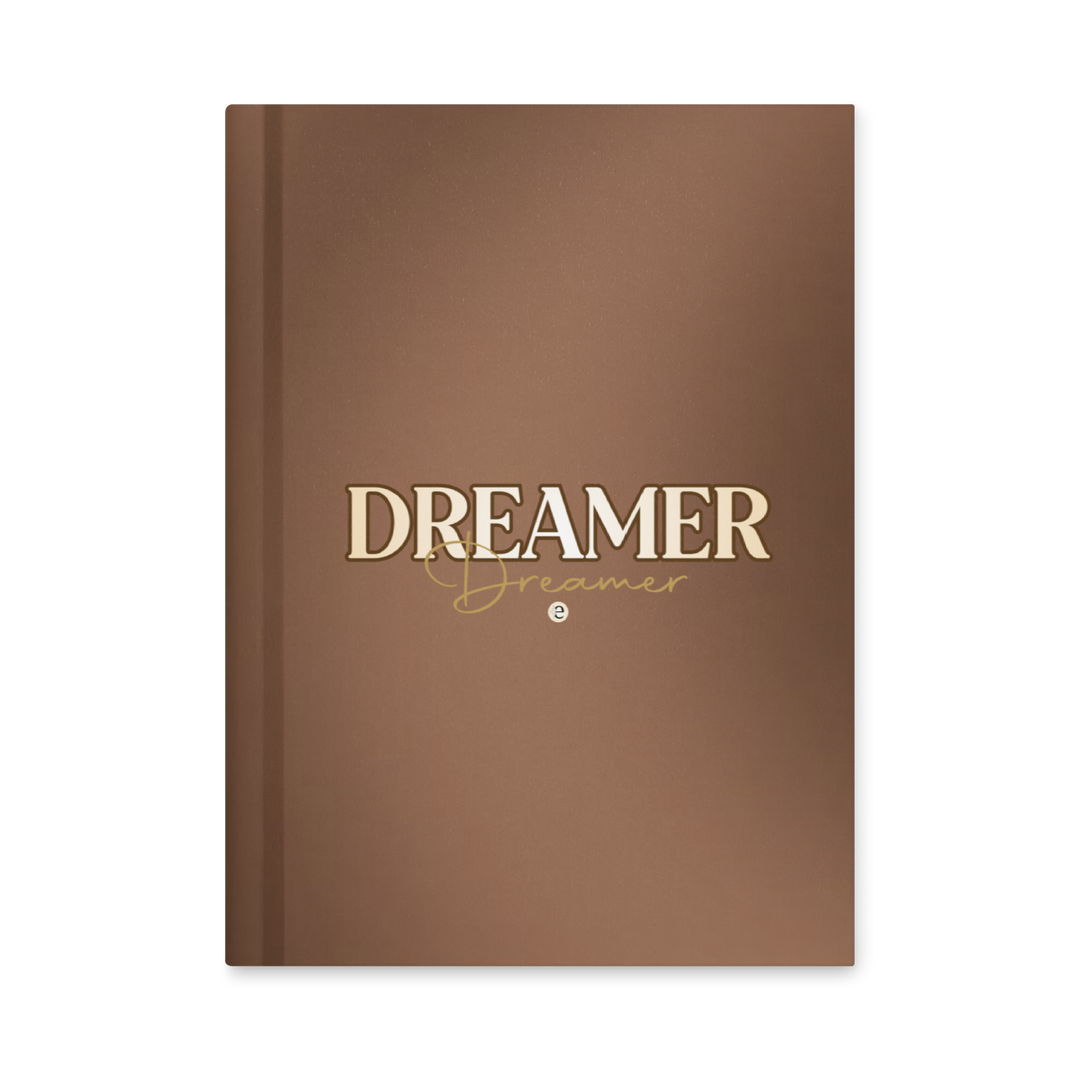 Brown notebook with 'Dreamer' text on a white background